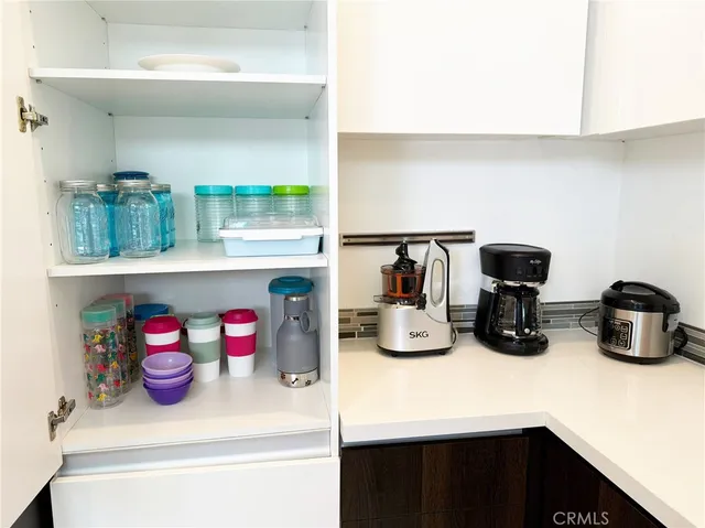 a kitchen with a sink and wooden floor