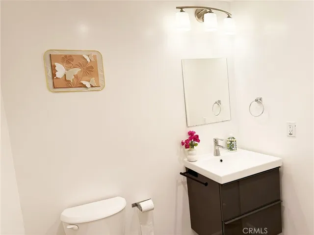 a bathroom with a sink mirror and toilet