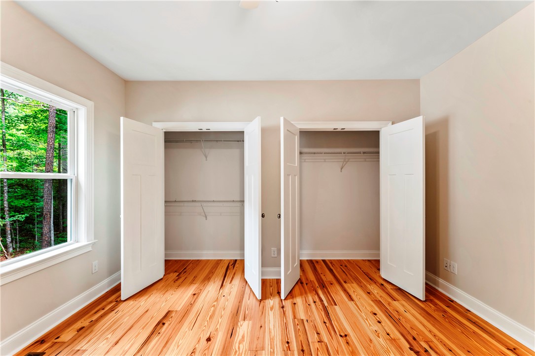 110 Gabriel Way Pickens, SC 29671 - Photo 26 of 48 Natural wood floors and dual closets complete this airy, well-lit bedroom.