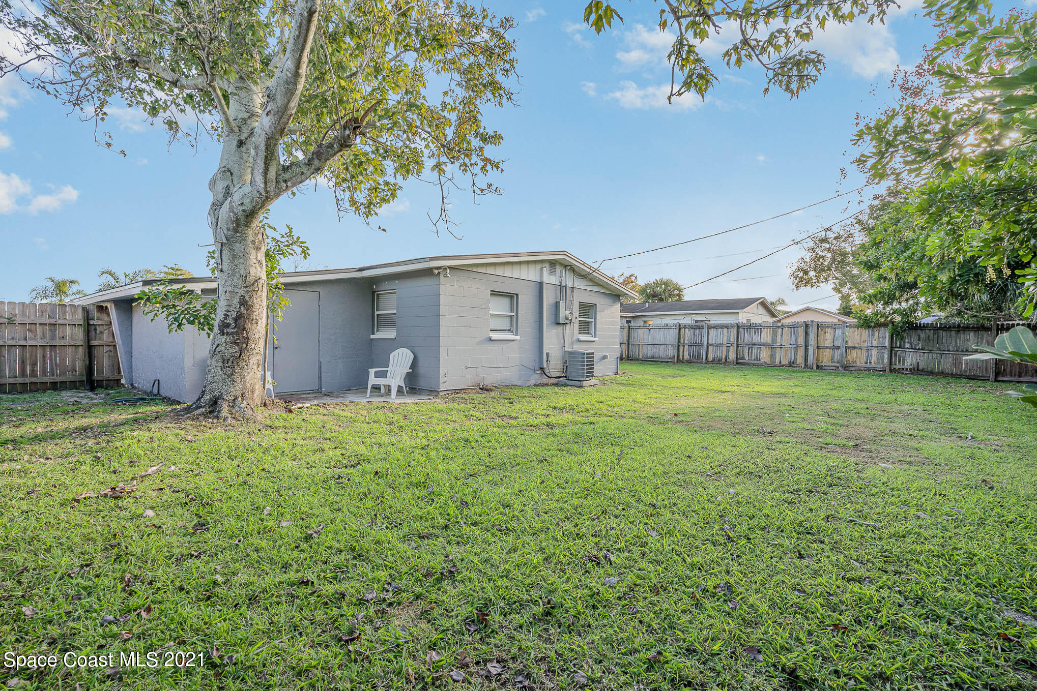 2210 Allan Adale Road Melbourne, FL 32935 - Photo 22 of 23 a view of a house with backyard and a tree