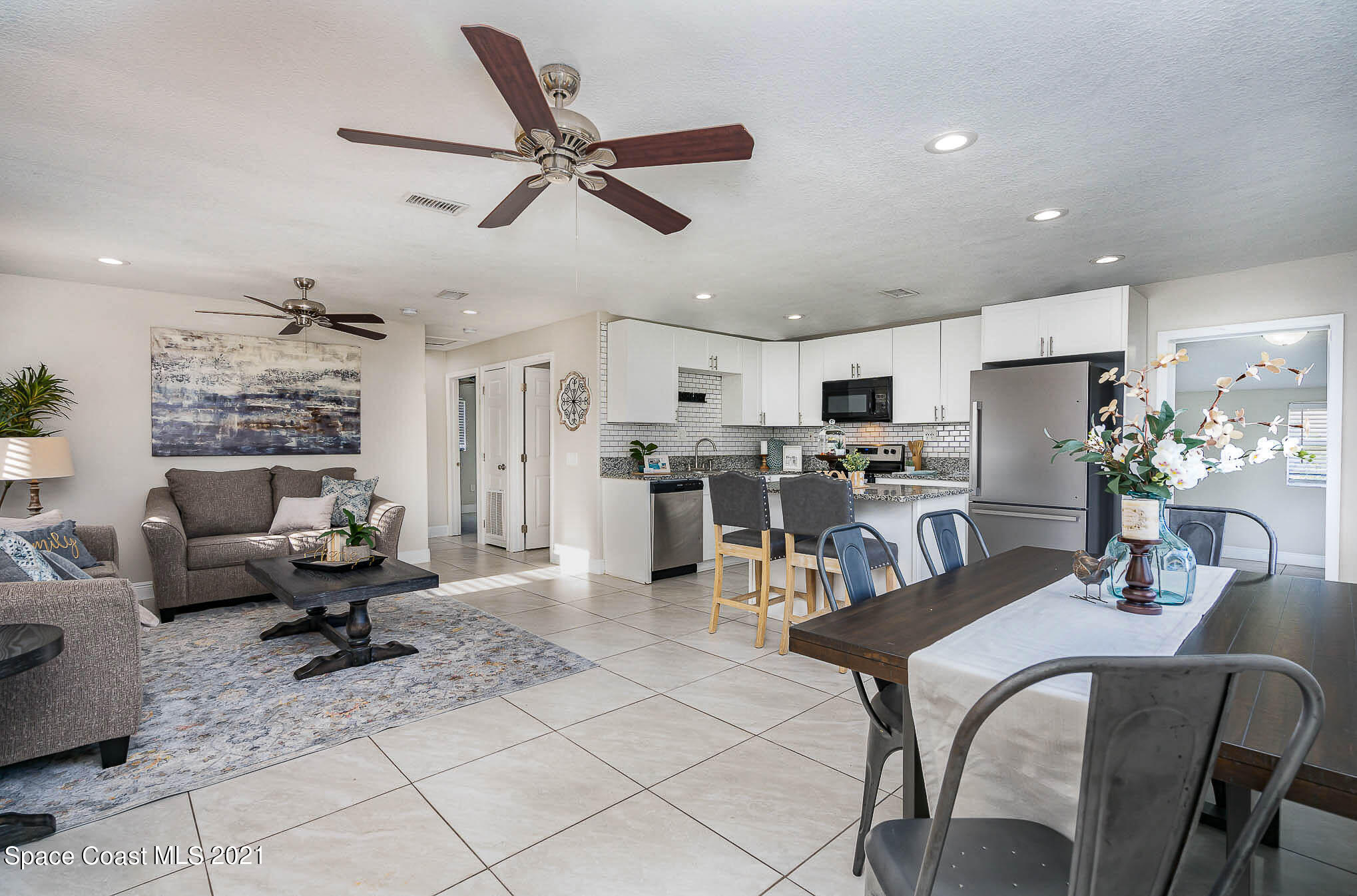 2210 Allan Adale Road Melbourne, FL 32935 - Photo 3 of 23 a living room with furniture and kitchen view