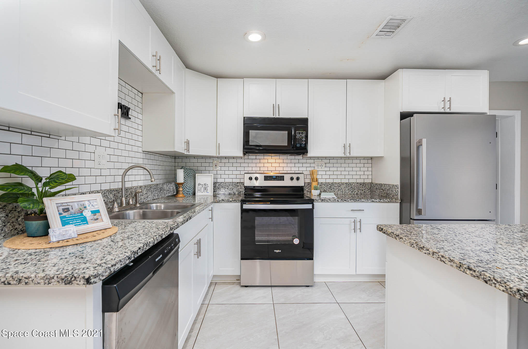 2210 Allan Adale Road Melbourne, FL 32935 - Photo 6 of 23 a kitchen with granite countertop a stove sink and refrigerator
