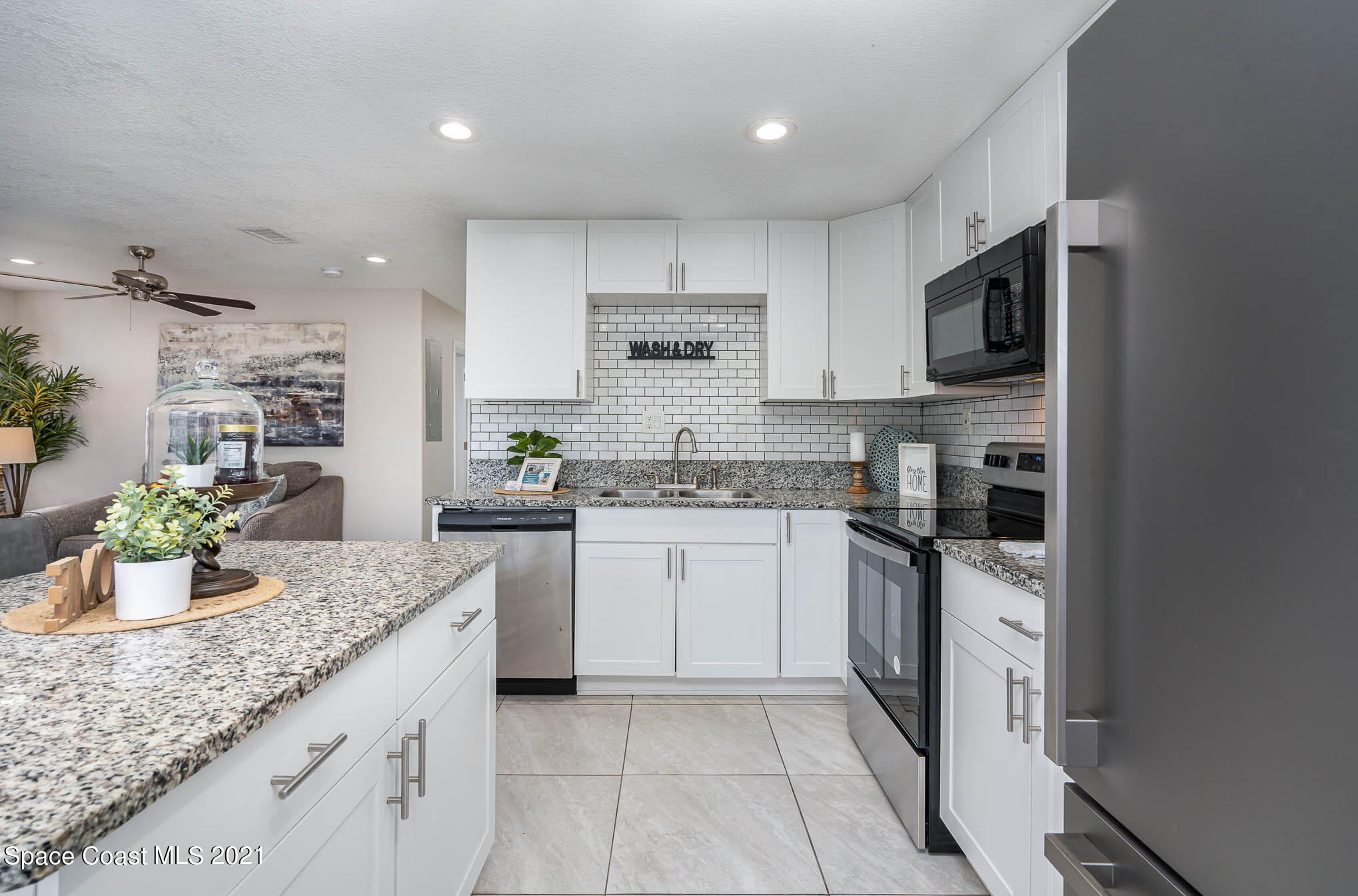2210 Allan Adale Road Melbourne, FL 32935 - Photo 7 of 23 a kitchen with stainless steel appliances granite countertop a sink and a stove