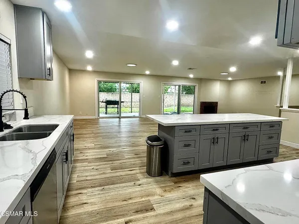 a large kitchen with kitchen island a sink stainless steel appliances and cabinets