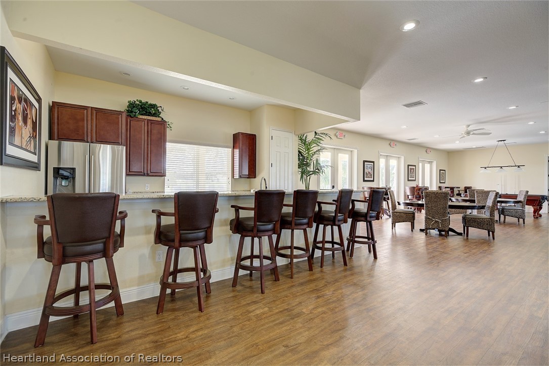 1388 Stone Circle Sebring, FL 33870 - Photo 19 of 31 a view of a dining room with furniture and wooden floor