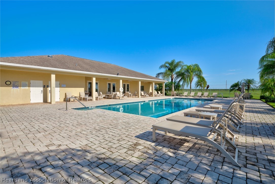 1388 Stone Circle Sebring, FL 33870 - Photo 30 of 31 a view of a house with swimming pool and porch