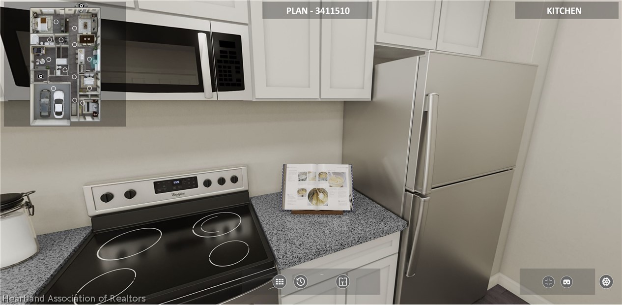1388 Stone Circle Sebring, FL 33870 - Photo 5 of 31 a kitchen with a stove and a microwave