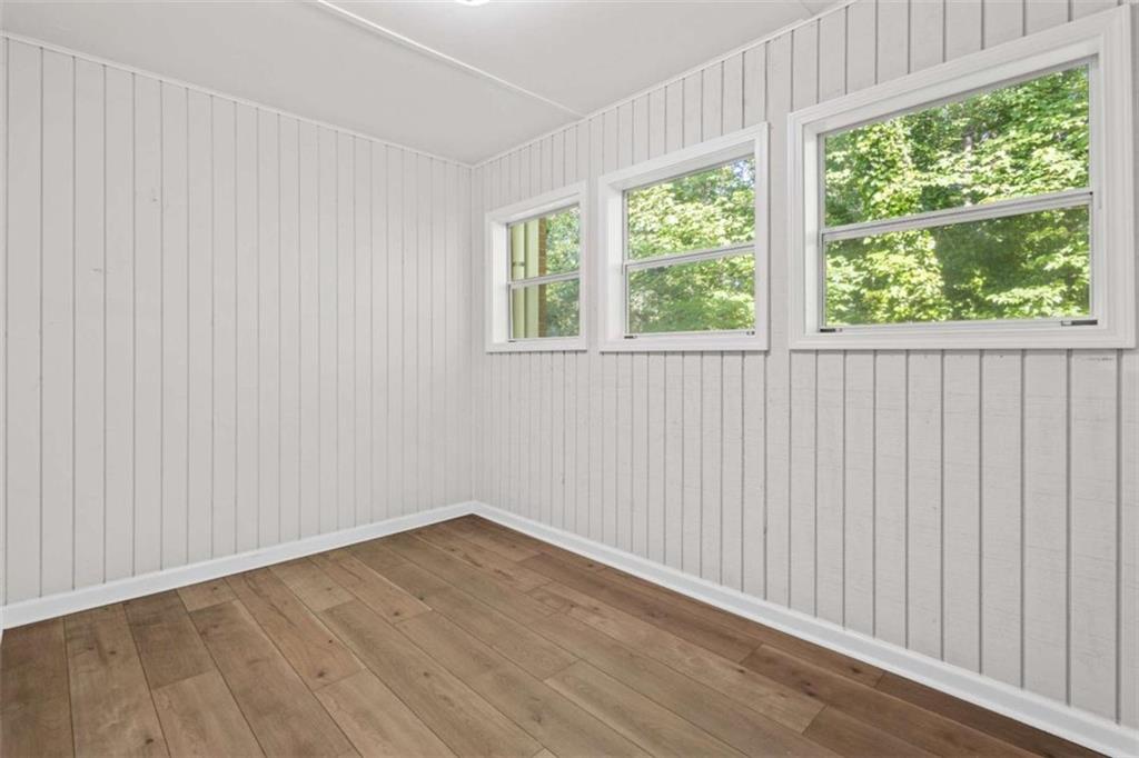 1166 Booth Road, Unit 407 Marietta, GA 30008 - Photo 10 of 18 wooden floor in an empty room with a window