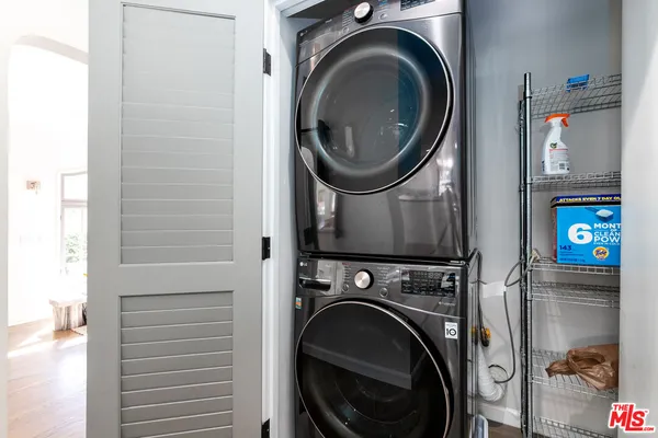 a view of a storage and utility room with washer and dryer