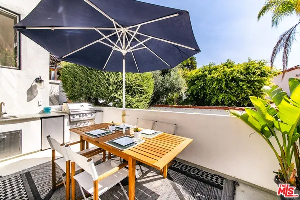 a patio with a patio table and chairs