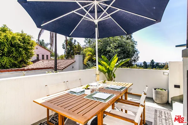 a view of balcony with furniture and umbrella