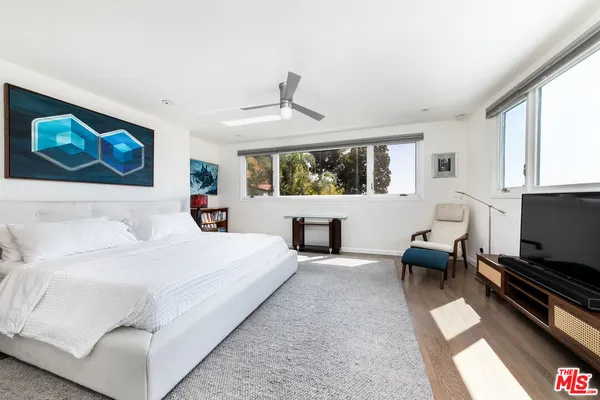 a bedroom with furniture and windows