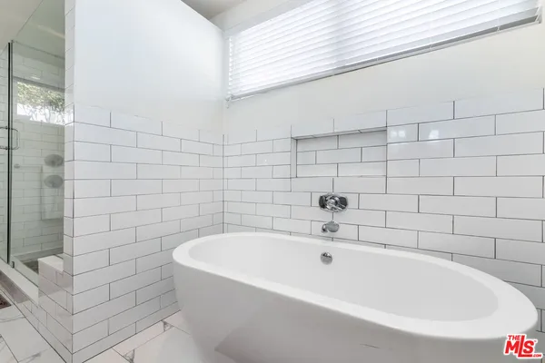 a white bath tub sitting in a bathroom