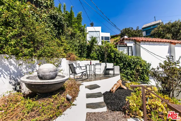 a view of a balcony with chair and a potted plant