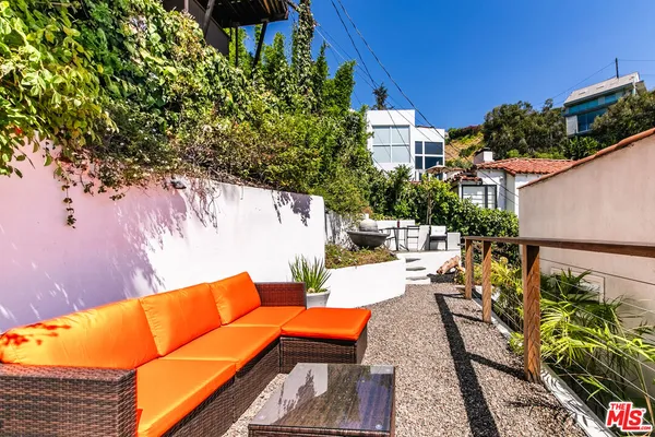 swimming pool with outdoor seating and plants