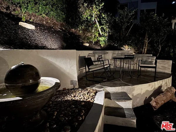 a backyard of a house with table and chairs