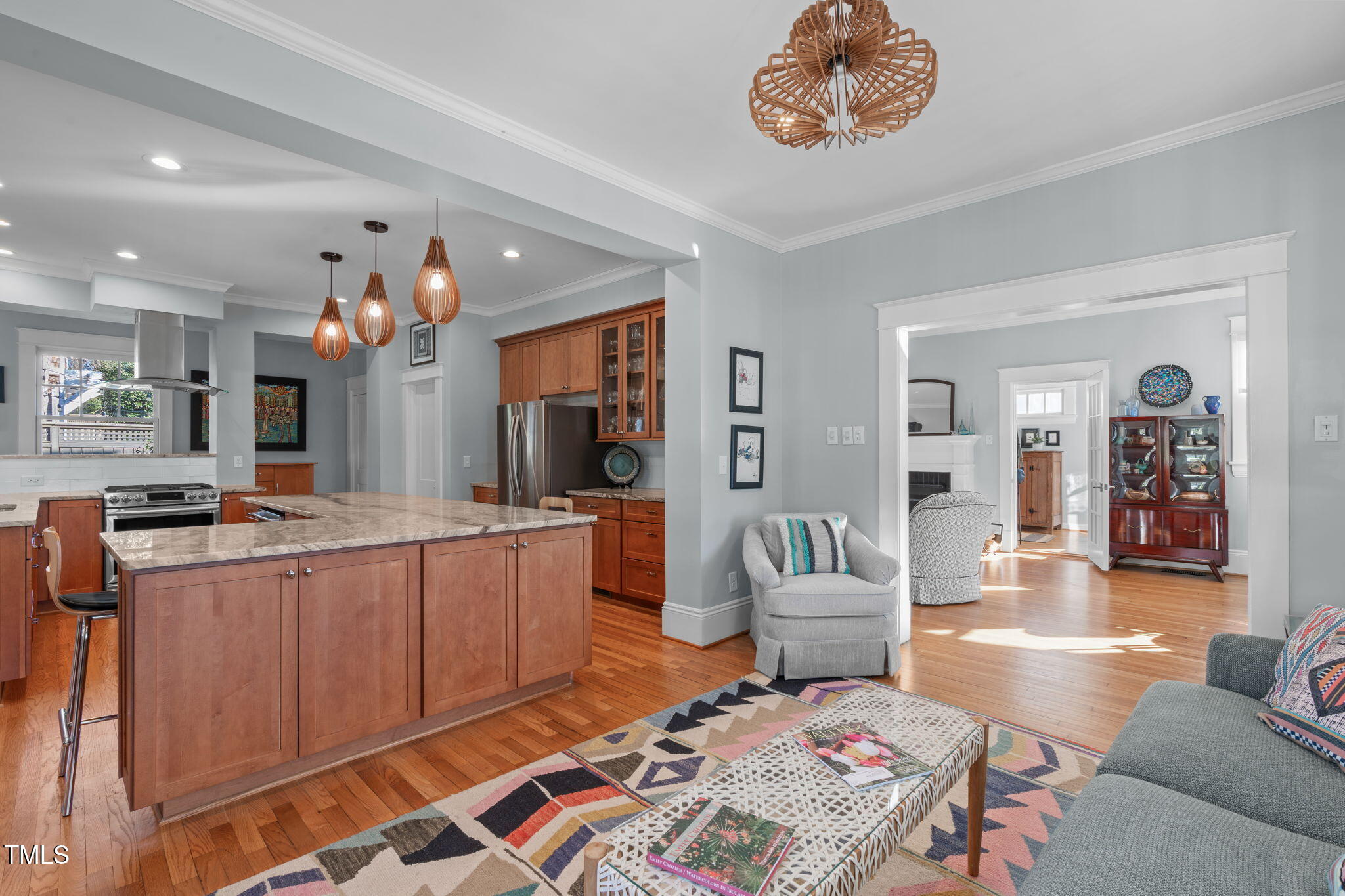 202 Duncan Street Raleigh, NC 27608 - Photo 13 of 46 a living room with kitchen island furniture and a chandelier