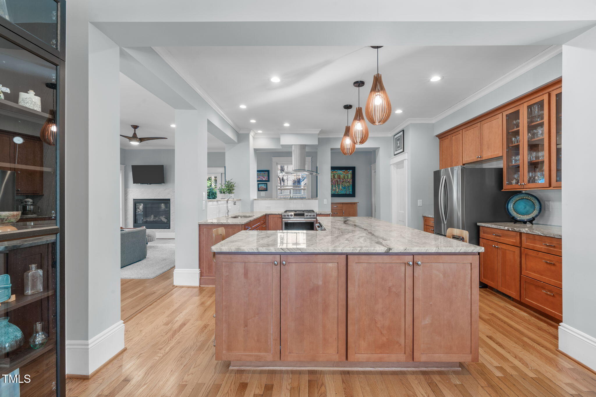 202 Duncan Street Raleigh, NC 27608 - Photo 14 of 46 a large kitchen with kitchen island a island a stove a sink a refrigerator and a wooden floor