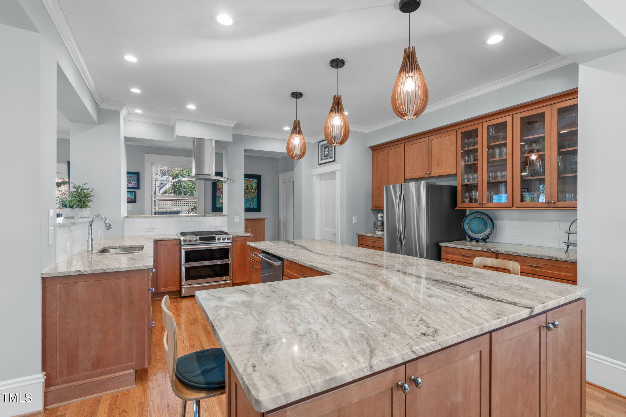 202 Duncan Street Raleigh, NC 27608 - Photo 15 of 46 a kitchen with stainless steel appliances granite countertop a sink a stove and a wooden cabinets