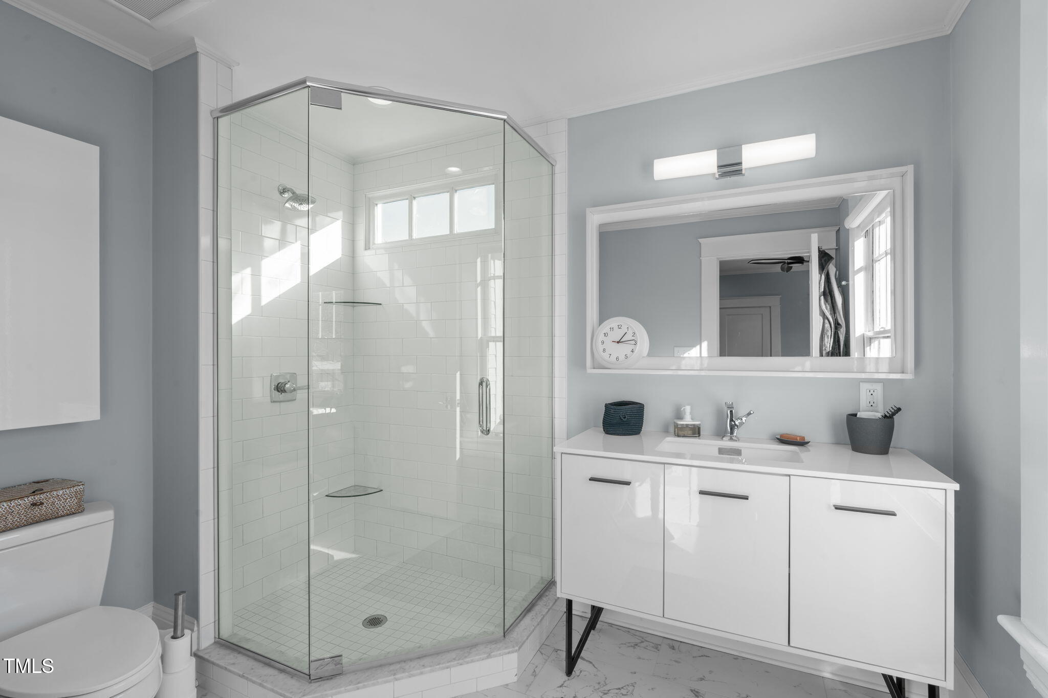 202 Duncan Street Raleigh, NC 27608 - Photo 24 of 46 a bathroom with a shower sink vanity and mirror