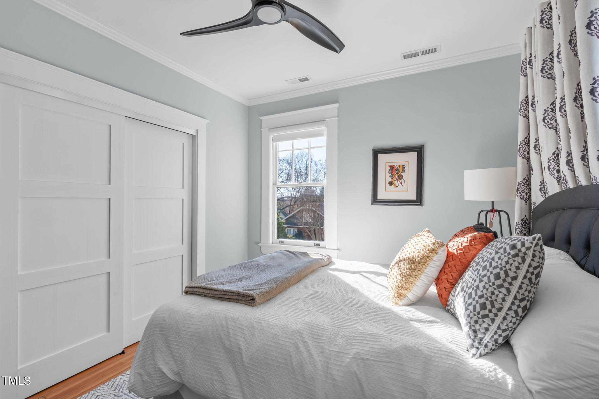 202 Duncan Street Raleigh, NC 27608 - Photo 28 of 46 a bedroom with a large bed and a window