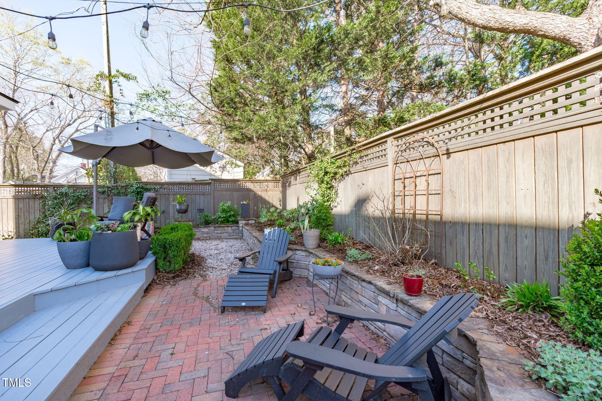 202 Duncan Street Raleigh, NC 27608 - Photo 29 of 46 a view of a patio with couches table and chairs and potted plants