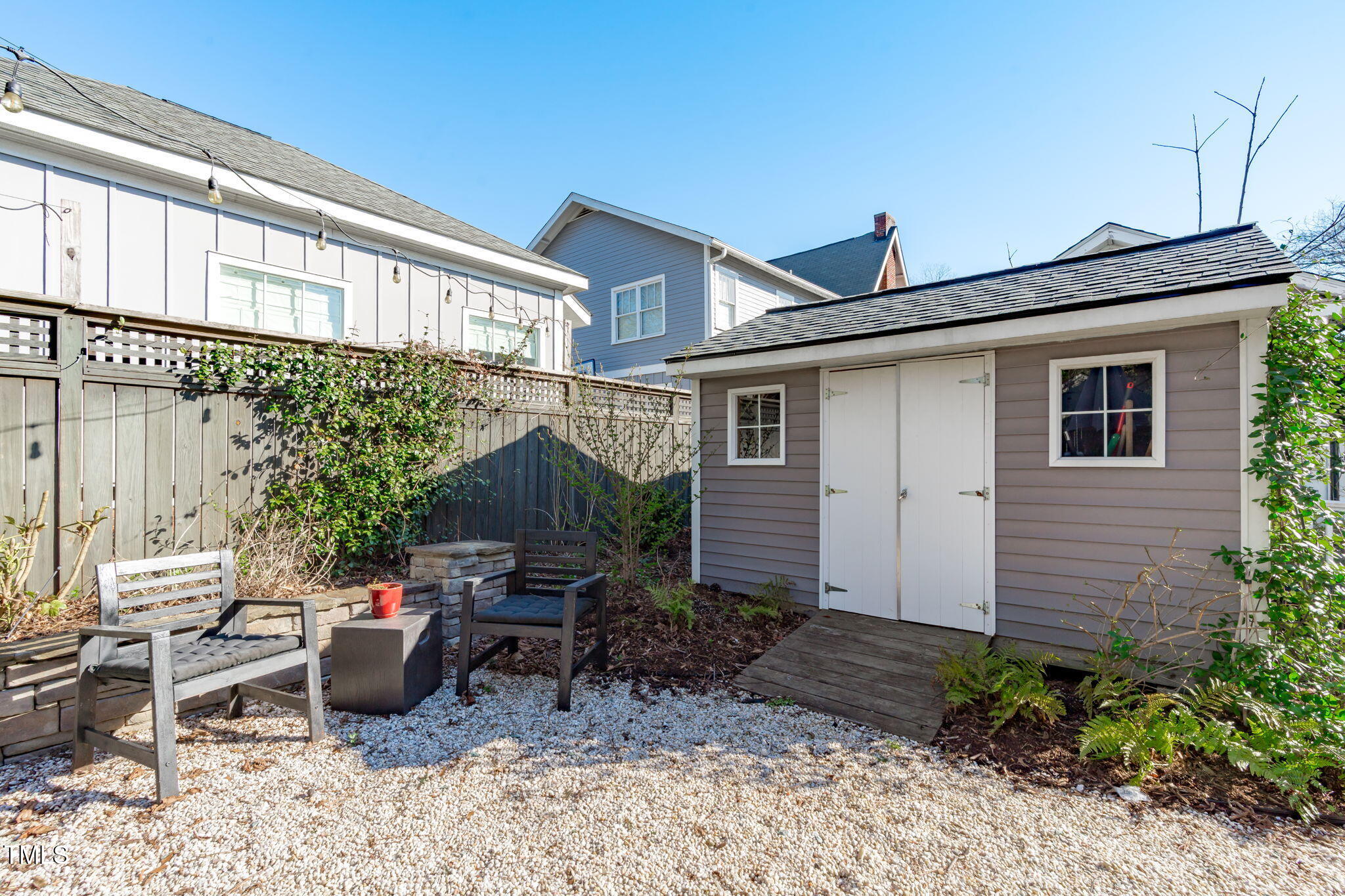 202 Duncan Street Raleigh, NC 27608 - Photo 32 of 46 a backyard of a house with outdoor seating and barbeque oven