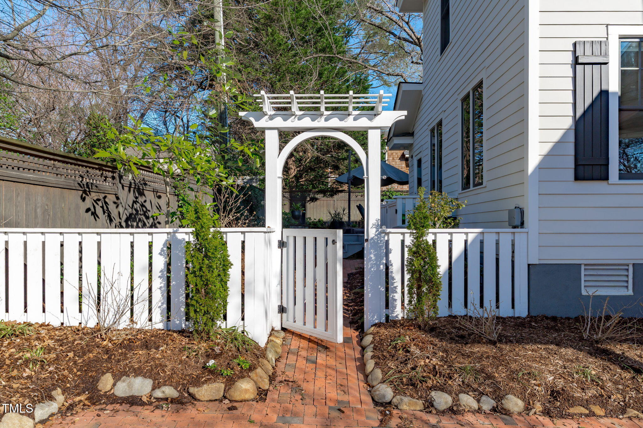 202 Duncan Street Raleigh, NC 27608 - Photo 8 of 46 a view of a house with a small yard and wooden fence