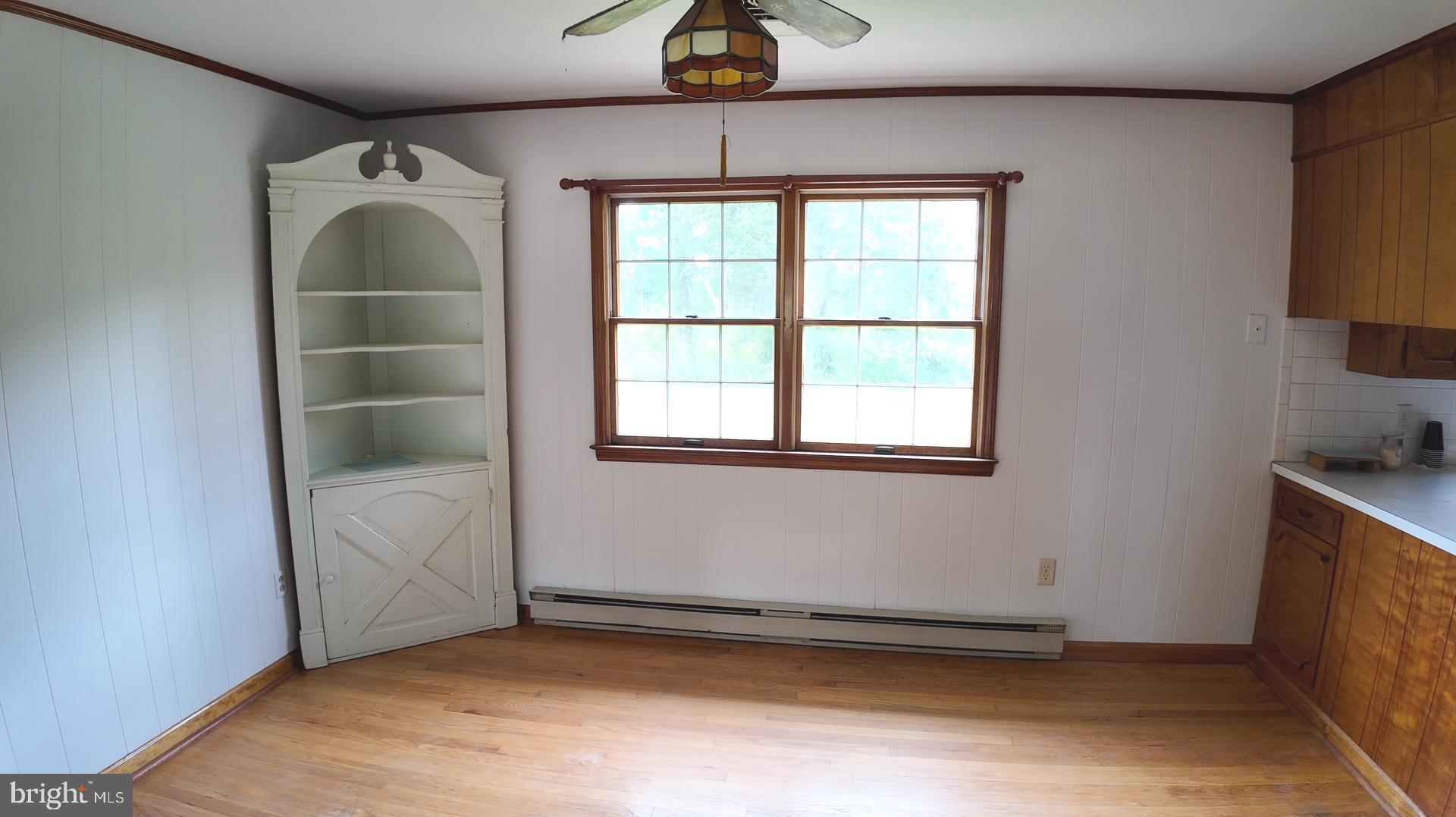 8936 Goldsborough Neck Road Easton, MD 21601 - Photo 3 of 13 wooden floor in an empty room with a window
