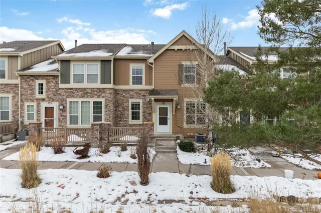 a view of a house with a yard covered in snow