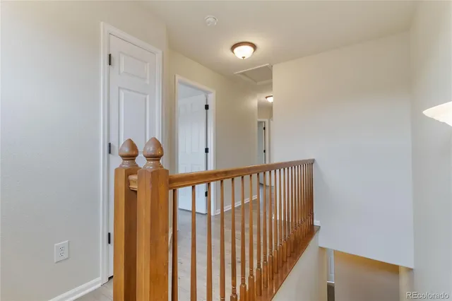 a view of hallway with wooden floor
