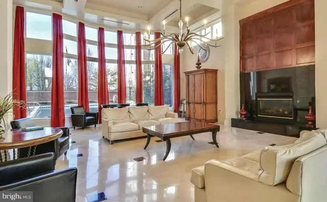 a living room with furniture a large window and a fireplace