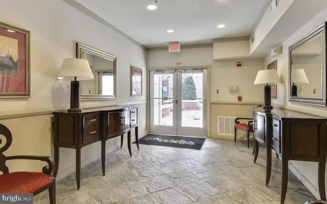 a living room with furniture a fireplace and a chandelier
