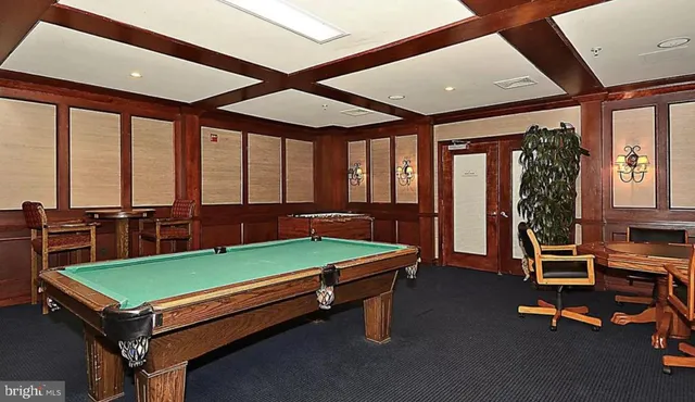 a room with pool table and windows