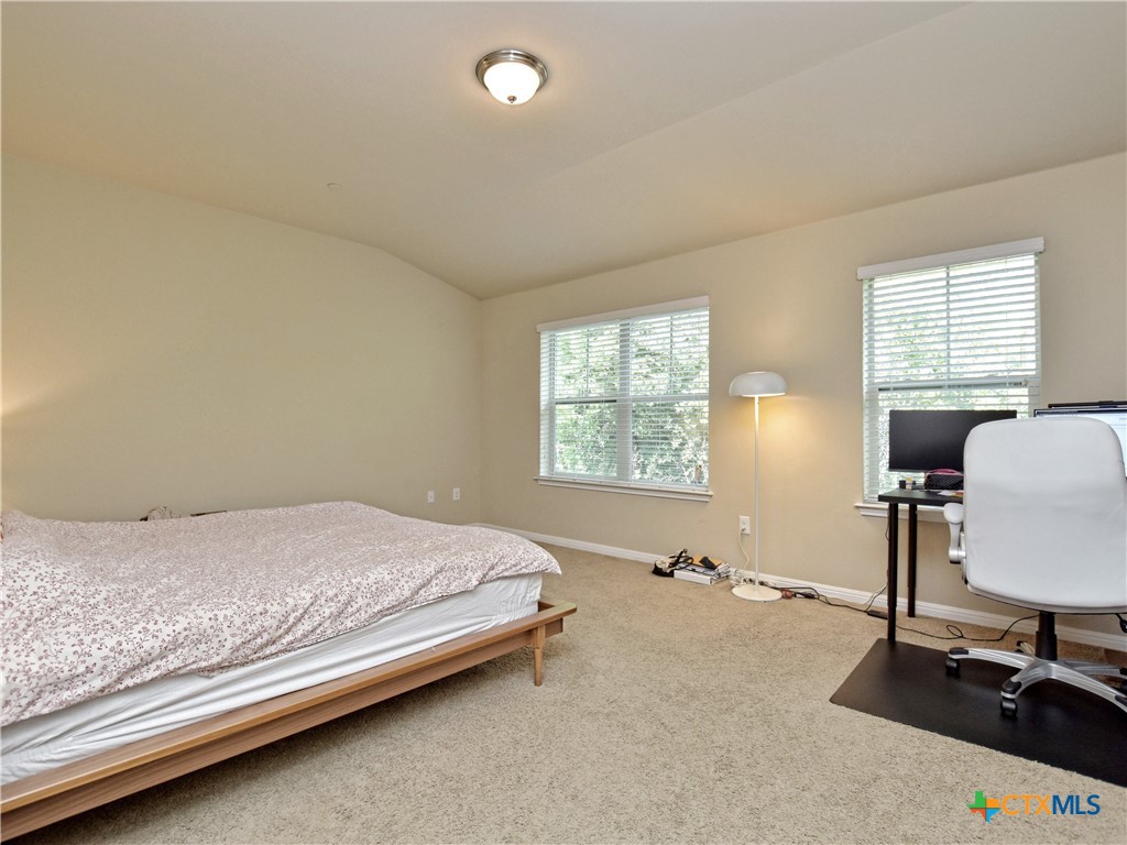 516 East Slaughter Lane, Unit 1801 Austin, TX 78744 - Photo 14 of 30 a bed room with a bed and a desk