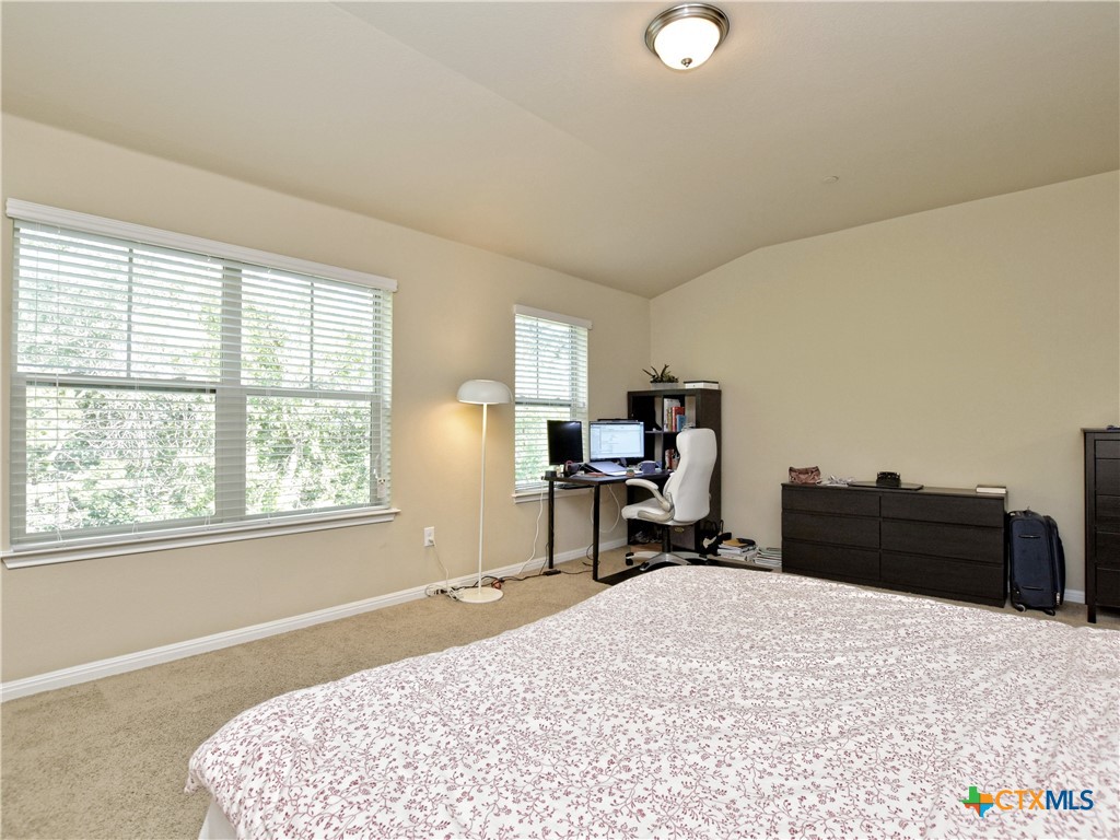 516 East Slaughter Lane, Unit 1801 Austin, TX 78744 - Photo 15 of 30 a bed room with a bed and a chair