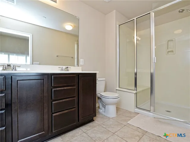 a bathroom with a toilet a sink and shower