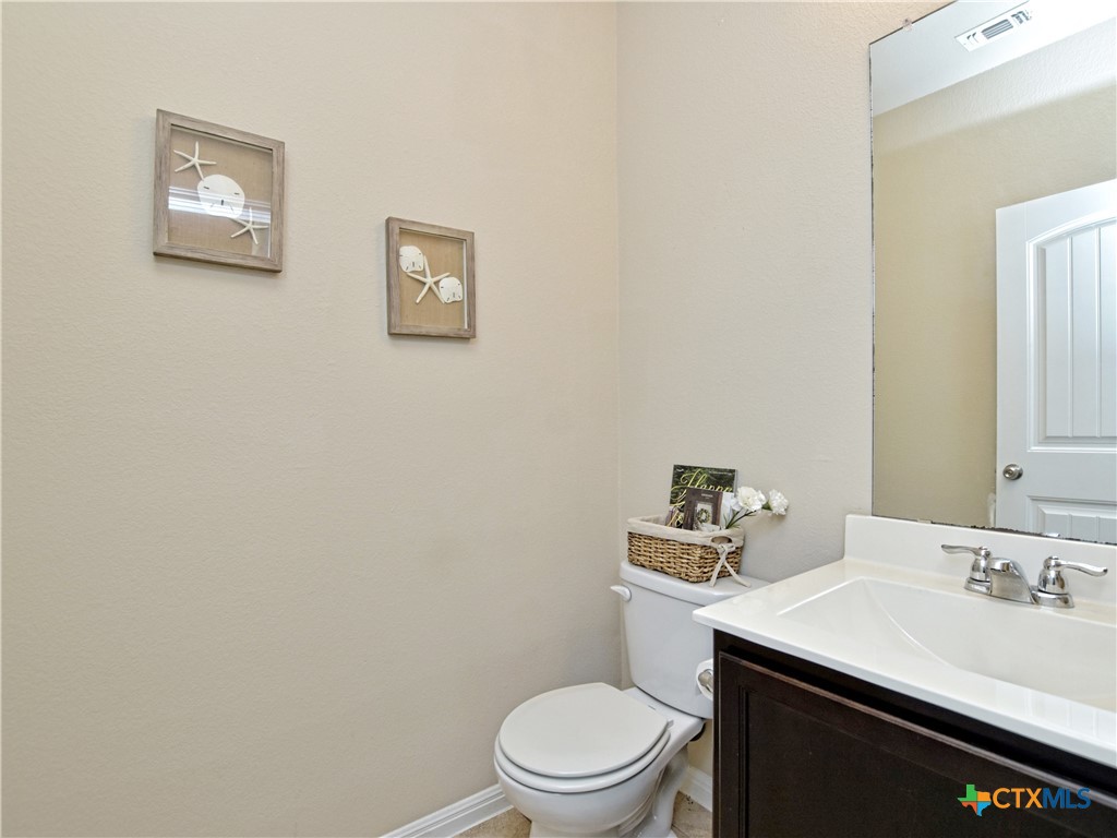 516 East Slaughter Lane, Unit 1801 Austin, TX 78744 - Photo 21 of 30 a bathroom with a sink a toilet and a mirror