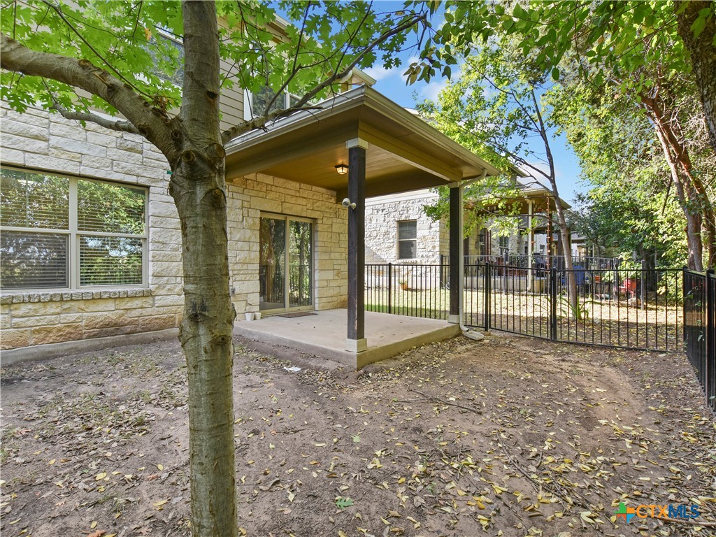 516 East Slaughter Lane, Unit 1801 Austin, TX 78744 - Photo 24 of 30 a view of a house with a small yard and large tree