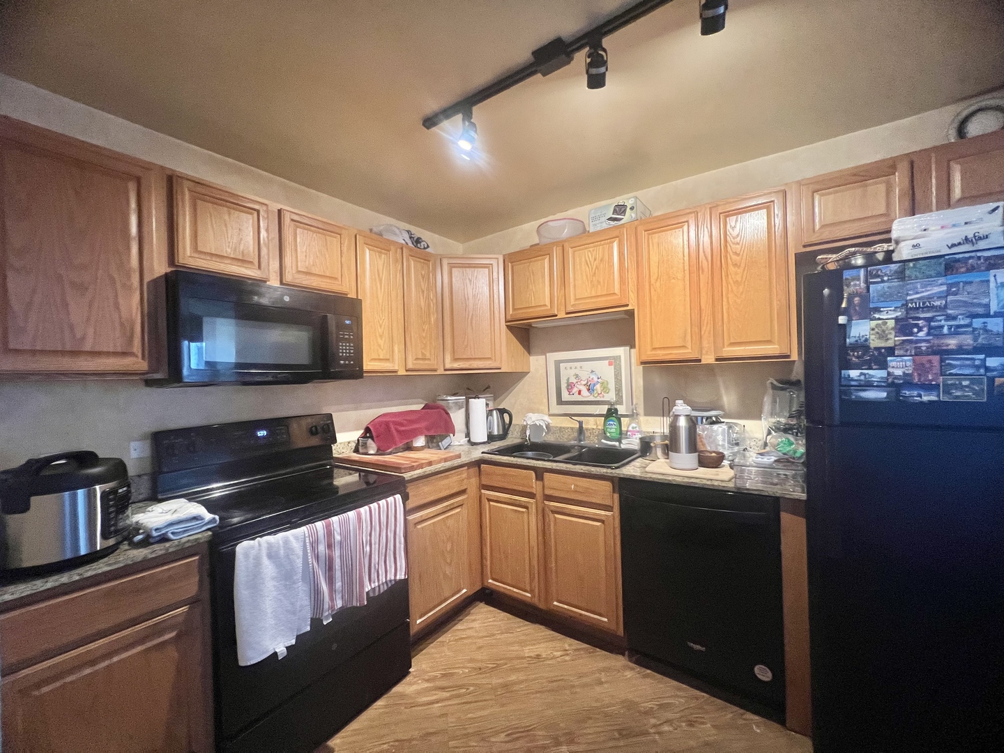 5320 North Sheridan Road, Unit 2203 Chicago, IL 60640 - Photo 8 of 27 a kitchen with a sink a stove a microwave and cabinets