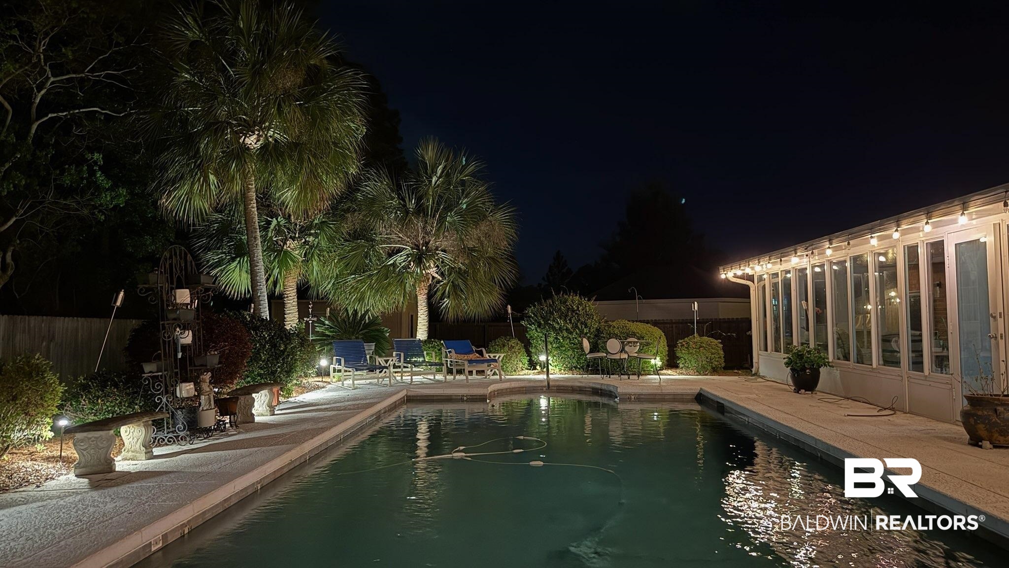 373 Collinwood Loop Foley, AL 36535 - Photo 42 of 49 Pool at night featuring a fenced backyard, a patio, and a sunroom