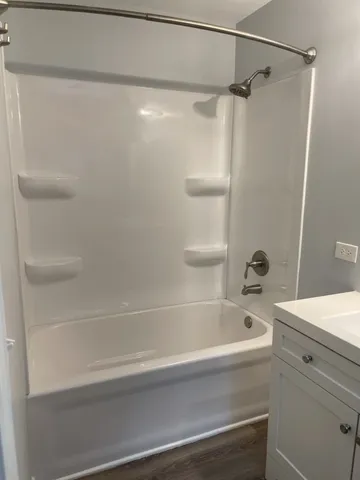 a bathroom with a bathtub and a shower