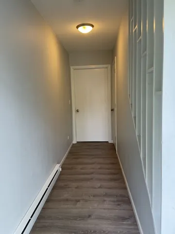 a view of a hallway with wooden floor