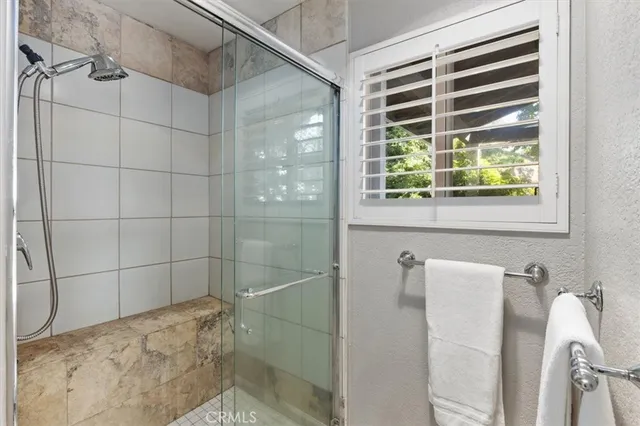 a bedroom with a bed and a large window