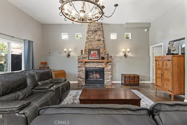a living room with patio fireplace furniture and a floor to ceiling window