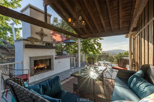 a view of a patio with table and chairs under an umbrella