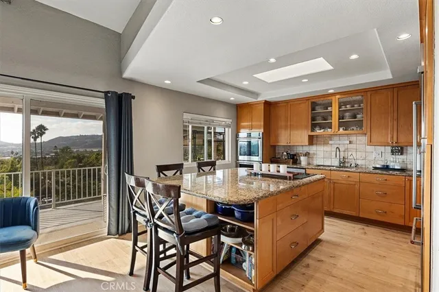 a kitchen with refrigerator and chairs