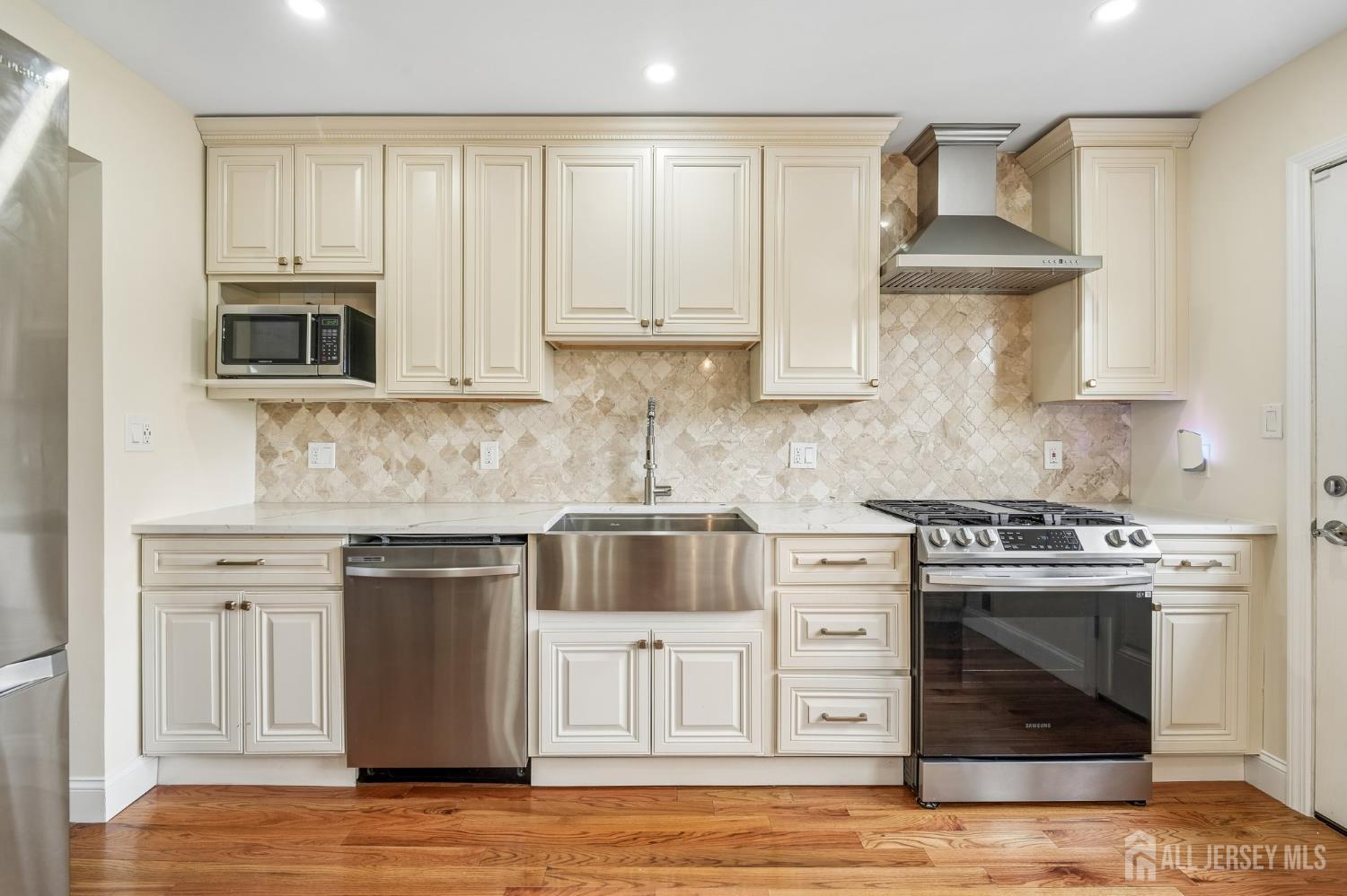 2 Marc Court Edison, NJ 08820 - Photo 13 of 23 a kitchen with cabinets stainless steel appliances and wooden floor