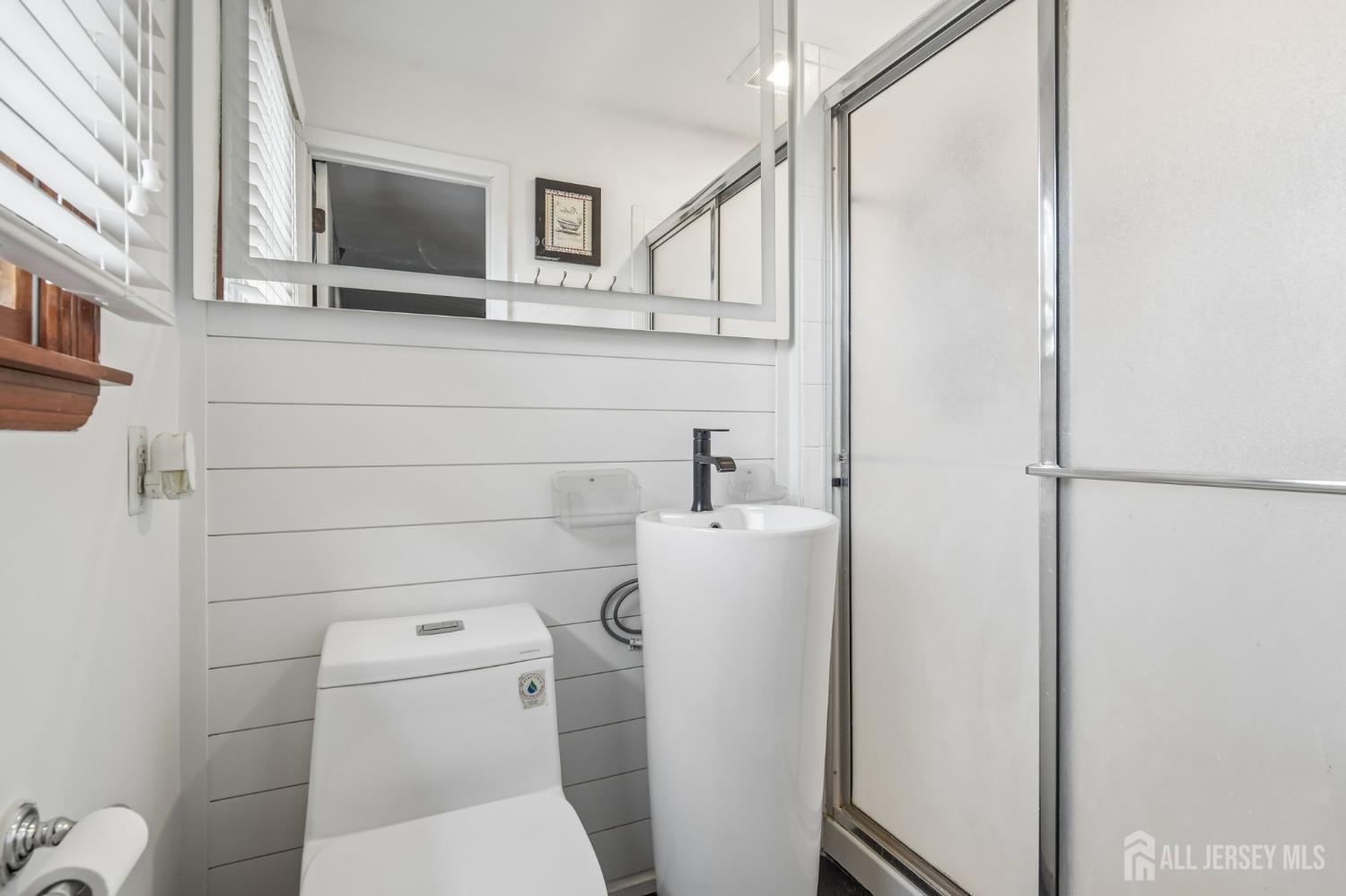 2 Marc Court Edison, NJ 08820 - Photo 19 of 23 a bathroom with a toilet sink and mirror