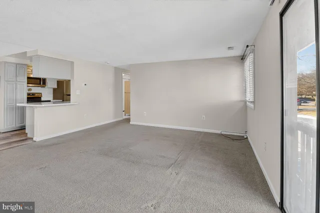 a view of a kitchen with a sink and a refrigerator